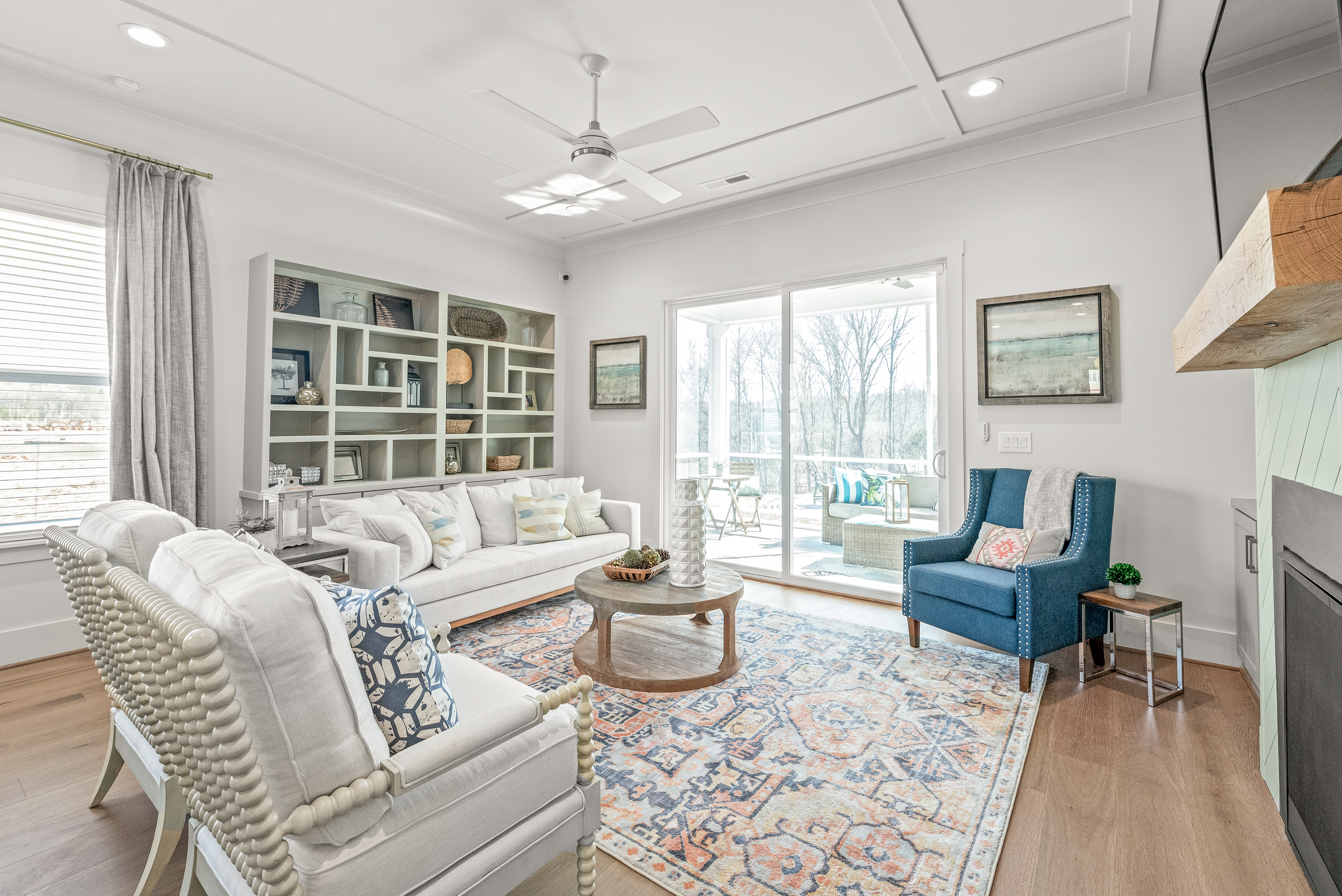 Living room with bookcase, sliding glass door and couches