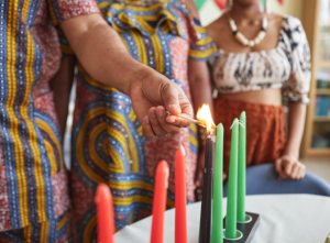people lighting kwanzaa candles